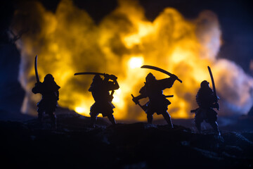 Samurai fighting concept. Silhouette of samurais in duel near tree and old temple. Table decoration...