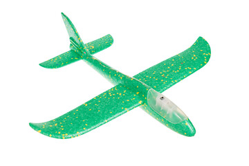 Green toy airplane, glider, made of foam, lightweight, for launching on the street, isolated on a...