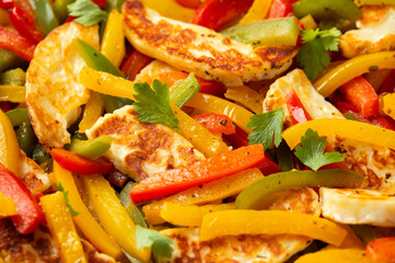 Tasty Halloumi cheese Fajitas with mix pepper in iron cast pan. Healthy food.
