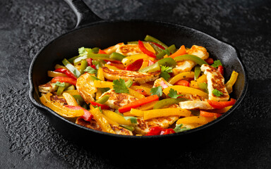 Tasty Halloumi cheese Fajitas with mix pepper in iron cast pan. Healthy food.