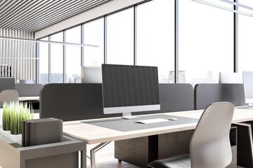 Close up of desktop with empty computer screen in modern office interior with city view and daylight. 3D Rendering.