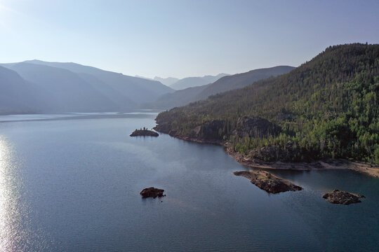 Aerial view of Lake Granby, Colorado and surrounding mountains and forests on clear calm summer morning.
