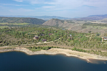 Aerial view of Lake Granby, Colorado and surrounding mountains and forests on calm sunny summer morning.
