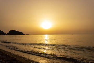 Beautiful view of seaside at dawn. Sunrise view with waves and sea. Landscape of rising sun over the sea in Cirali, Antalya, Turkey.