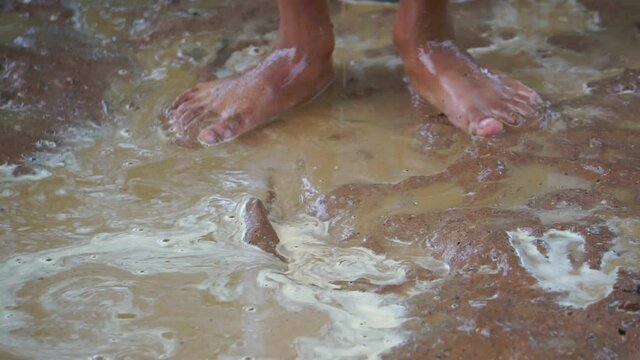 Underprivileged children happily playing in muddy water