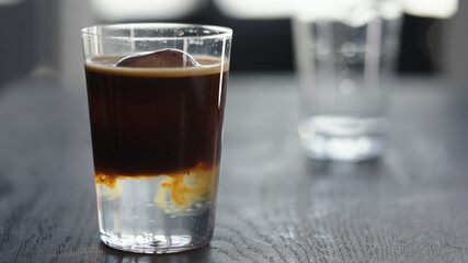 Making espresso tonic in tumbler with ice ball
