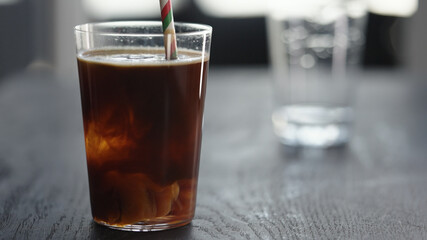 Making espresso tonic in tumbler with ice ball