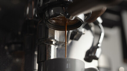 Fototapeta na wymiar Low angle of pulling espresso shot with naked portafilter