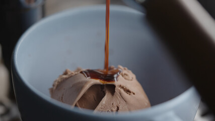 Making affogato with chocolate ice cream in blue cup