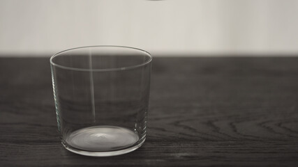 Empty tumbler glass on oak table