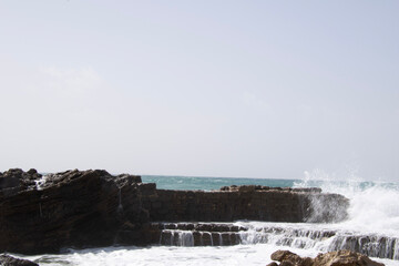 waves crashing on a rock