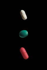 three pills on a black background