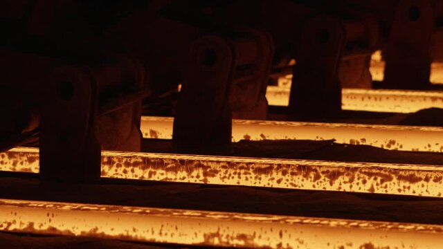 Red hot steel metal billets after molten steel casting.Continuous casting machine. Heavy industry, foundry, metal products Steel billets at torch cutting in metallurgical plant.