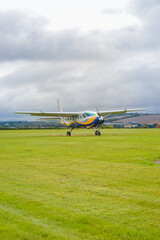 A small plane from 'GoSkydive' awaits people to land for parachute jumping