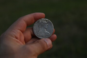 Vintage silver Austrian coin in hand