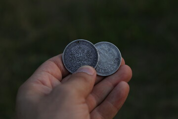 Vintage Russian silver coins in hand - obrazy, fototapety, plakaty