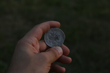 Silver medieval coin in hand