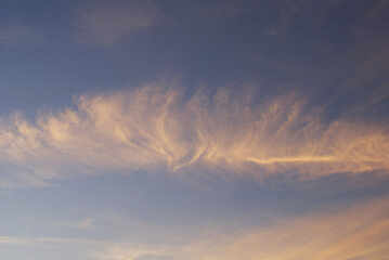 Beautiful clouds on the background of the sunset.