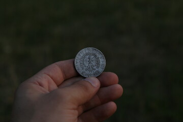 Old silver Polish coin in hand