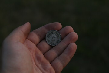 Old Arab coin in hand
