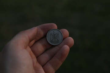 Old Arab coin in hand