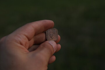 Old coin one cent in hand