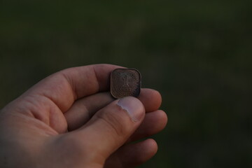 Old coin one cent in hand