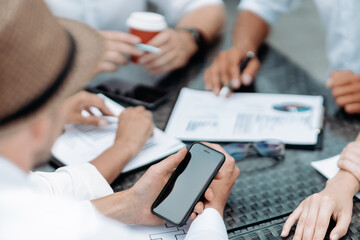 businessman using a smartphone during an office meeting.