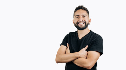 Fototapeta premium man in black shirt smiling with arms crossed on white background