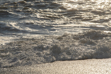 white sea foam near the shore close-up, waves