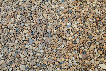 Abstract background with round pebble stones. Fine gravel, natural stones. Empty space on the background for the text.