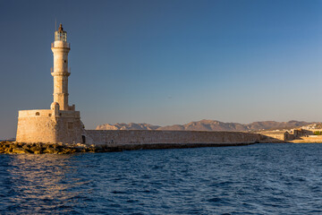 Ancient Venetian lighthouse at the old port of Chania (Crete) in the late evening sunshine
