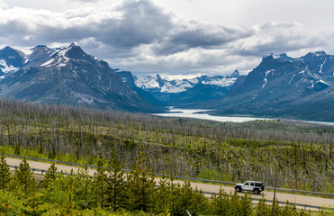Saint Mary Lake - A stormy Spring evening view of Highway 89 running at side of Saint Mary Lake and...