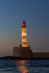 Ancient venetian lighthouse in the Cretan city of Chania at dusk