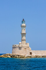 Fototapeta na wymiar An old stone lighthouse guarding the entrace to a port (Chania, Crete, Greece)