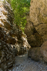 Fototapeta na wymiar A narrow gorge and dry riverbed in a hot climate (Imbros Gorge, Crete, Greece)