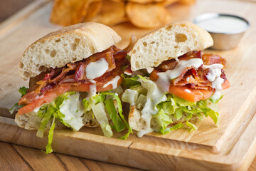 BLT sandwich. Bacon, Lettuce and Tomato Sandwich with fried eggs. Classic American Breakfast or Brunch menu item. Smoked bacon, beef steak tomatoes and lettuce on toasted whole wheat bread.