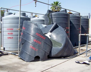 Plastic water tank damaged by a mortar blast on a camp in Baghdad, Iraq