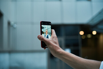 businessman talking to a colleague via video link.
