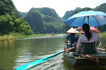 Foto op Canvas Vietnamese people and foreign traveler travel visit and amazing boat tour trip Tam Coc Bich Dong or Halong Bay on Land and Ngo Dong river and cave of limestone mountains at Ninh Binh in Hanoi, Vietnam © tuayai