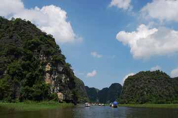 Fototapeta na wymiar Vietnamese people and foreign traveler travel visit and amazing boat tour trip Tam Coc Bich Dong or Halong Bay on Land and Ngo Dong river and cave of limestone mountains at Ninh Binh in Hanoi, Vietnam