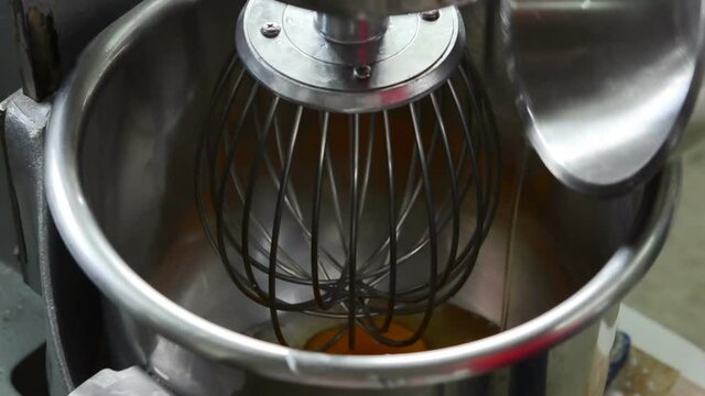 chef using machine to kneading egg and sugar for making dessert , Mixing with blender