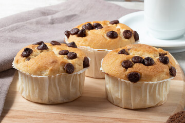 Breakfast time. Muffins with drops of chocolate and coffee.