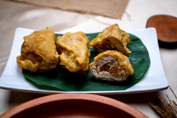 Tahu isi or Indonesian fried stuffed tofu, traditional snack made of crispy vegetable stuffed tofu, served with chili or chili sauce