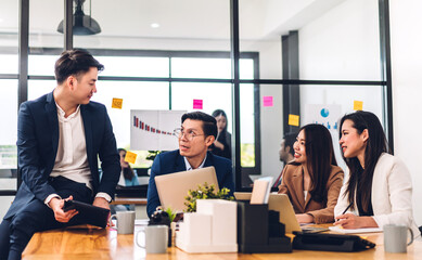 Group of professional success asian business meeting and discussing strategy with new startup project.Creative business people planning and brainstorm with laptop computer in modern office.Teamwork