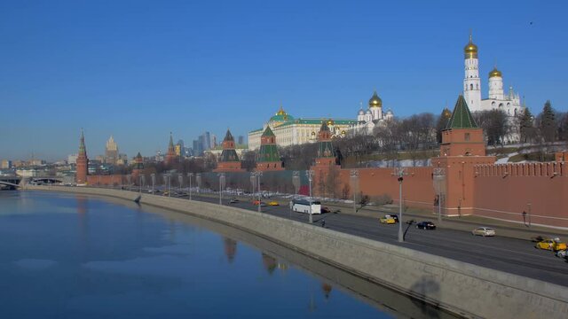 Moscow river and Kremlin in Russia, car traffic on city embankment