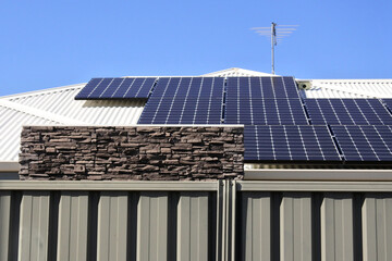 Fototapeta premium Modern house with solar panels on rooftops