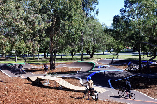 Group of BMX cyclists biking in outdoor cycling public park