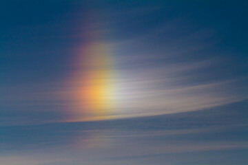 bright beautiful rainbow glows in the clear sky on an early summer morning at dawn