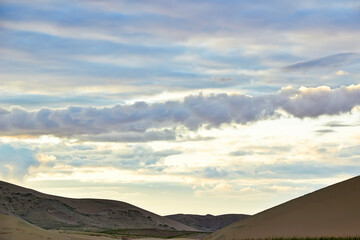 Evening cloudy sky over the sand dunes.